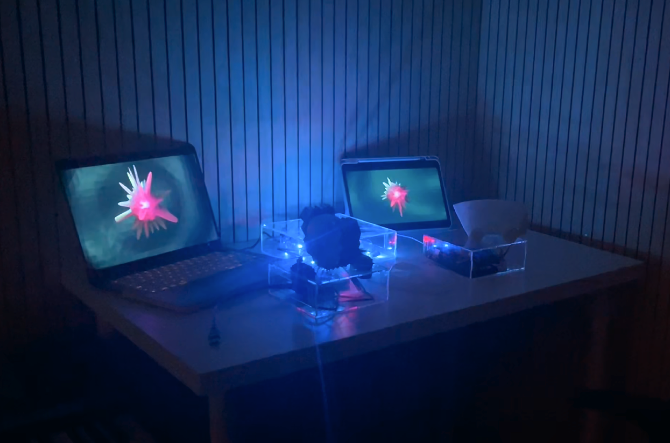 Blue-lit road rage experiment with two screens and a soft robotic form
